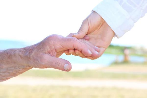 depositphotos_12232175-stock-photo-young-and-senior-women-holding